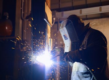 Man at work as welder in heavy industry